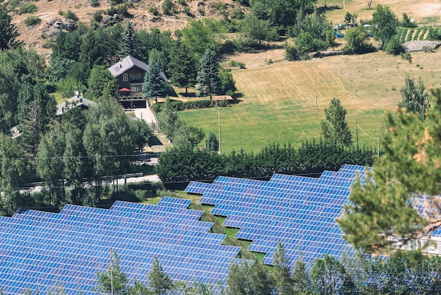 A close-up of a solar panel installation in a rural French landscape, with fields and trees in the background. The sun is shining brightly, highlighting the efficiency and importance of renewable energy sources in the French economy.