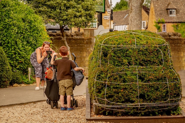 A vibrant photo of a historic French village, with tourists enjoying local food and culture. The scene captures the revitalization of the tourism sector through the French economic recovery plan.