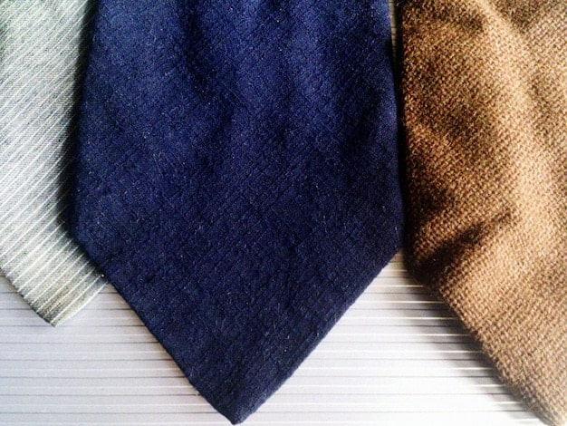 A close-up shot of different types of pantsuit fabrics and textures, including wool, linen, and silk blends, showcasing the quality and variety available in 2025.
