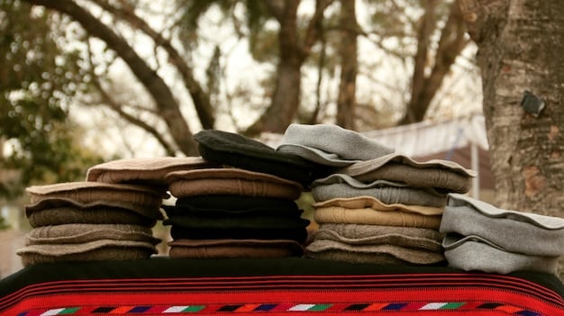 A stack of neatly folded used clothing is displayed in a brightly lit, modern thrift store. The clothing is a mix of colors and textures, representing a variety of styles. The focus is on the quality and care given to the items. In the background, shoppers are browsing through racks, emphasizing the appeal and accessibility of sustainable fashion practices.