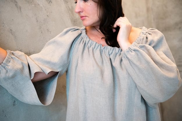 A close-up shot of a woman wearing a oversized linen shirt, paired with wide-leg cotton pants, showcasing the importance of comfortable and natural fabrics for creating a stylish yet effortless look.