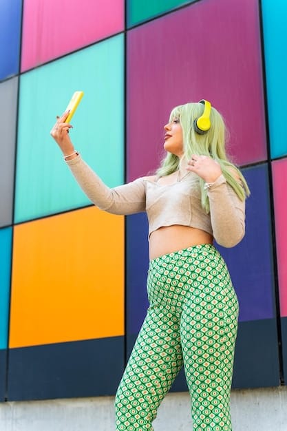 A plus-size fashion influencer is posing confidently in a bright, stylish outfit, while filming a video for her social media channel. The background is a colorful urban scene.