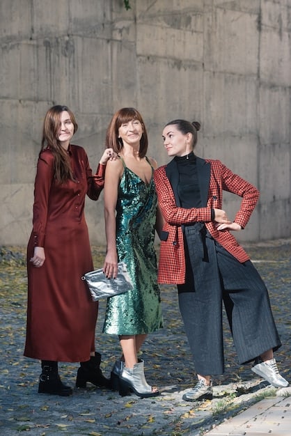 A group of diverse models walking down the runway in clothing that blends high fashion with sustainable materials at Paris Fashion Week. The setting is a modern, eco-friendly venue.