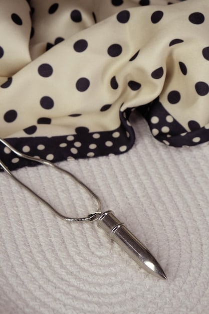 A close-up shot of a variety of modern accessories, including minimalist jewelry, silk scarves, slim belts, and structured handbags. The accessories are arranged on a neutral background to highlight their details and elegance.