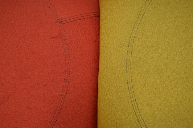 A close-up of two different patterned fabrics being held together, highlighting the color coordination and differences in pattern size.