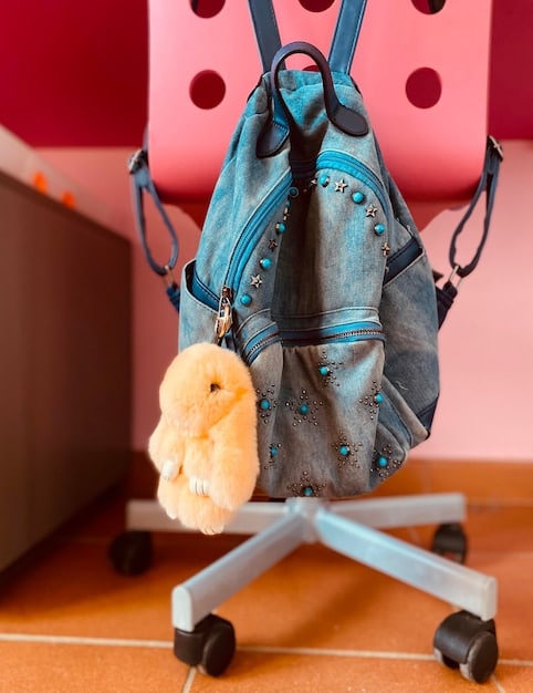 A selection of Shein's trendy bags and purses, including a mini backpack, a colorful crossbody bag, and a stylish tote bag, displayed on a white shelving unit. The image emphasizes the variety of styles and colors available in Shein's bag collection.