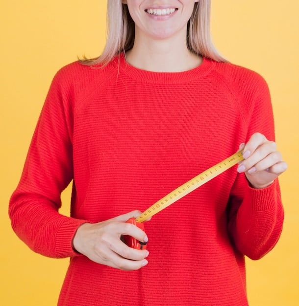 A close-up of a measuring tape showing inches and centimeters. The measuring tape is wrapped around a woman's waist, illustrating the importance of accurate measurements when shopping online.