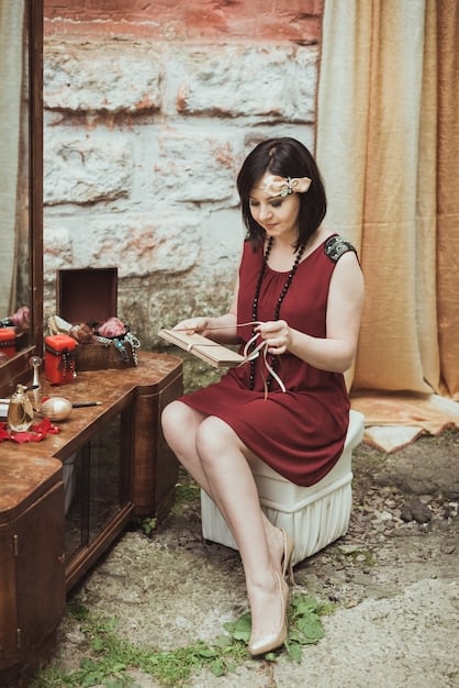 A woman in her 30s in France is creatively combining Shein trendy pieces with her classic wardrobe staples in a well-lit room.
