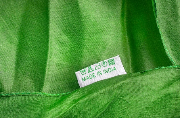 A close-up shot of a garment label which shows ecological certification badge, such as 