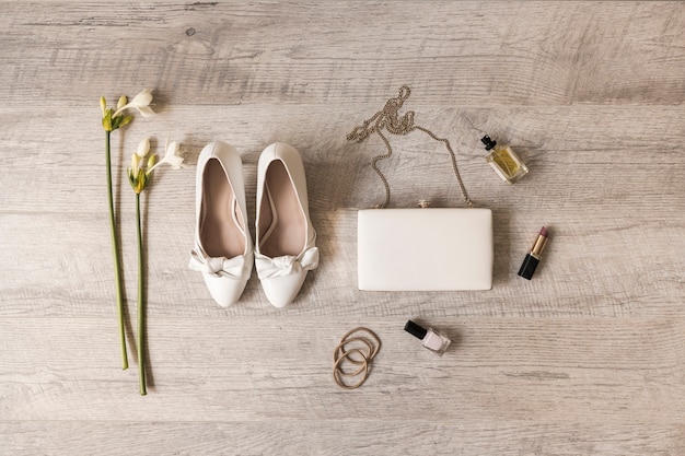 A flat lay displaying various accessories such as jewelry, clutches, and high heels, arranged around a Shein dress on a light-colored surface.