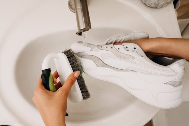 A woman carefully cleaning a white sneaker using a soft brush and a cleaning solution. She is focused and gentle, showcasing the proper technique for shoe cleaning.