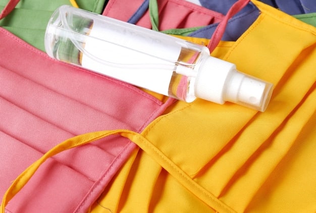 A detailed shot of a spray bottle filled with a clear liquid (e.g., white vinegar solution) being used to lightly mist a garment hanging on a clothes hanger.