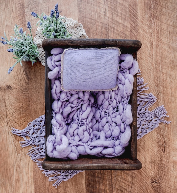A top-down view of a neatly organized drawer filled with clothing items, with small sachets of lavender strategically placed among the clothes to keep them smelling fresh.