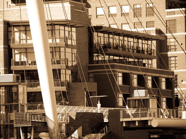 A construction site in a city, showing the early stages of building a multi-story residential complex. Heavy machinery is present, and workers are visible, indicating progress in addressing the housing shortage.