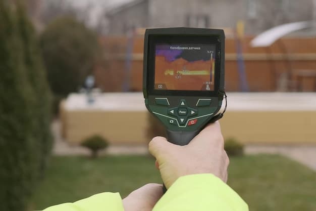 Close-up of a technician using a thermal imaging camera to detect a methane leak on a pipeline joint, showcasing the technology used for monitoring methane emissions.