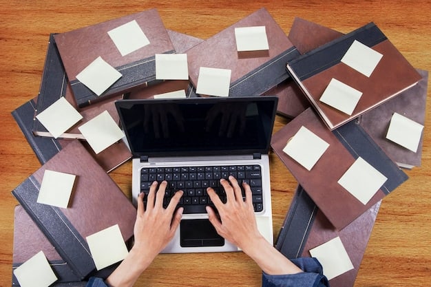 A person working on a laptop with documents spread around, symbolizing the preparation and documentation involved in the VAE process.