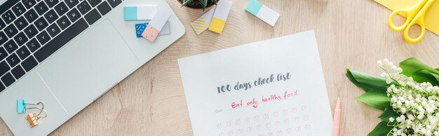 A calendar marked with important dates related to parental leave and childcare, on a desk with a laptop and notebook.