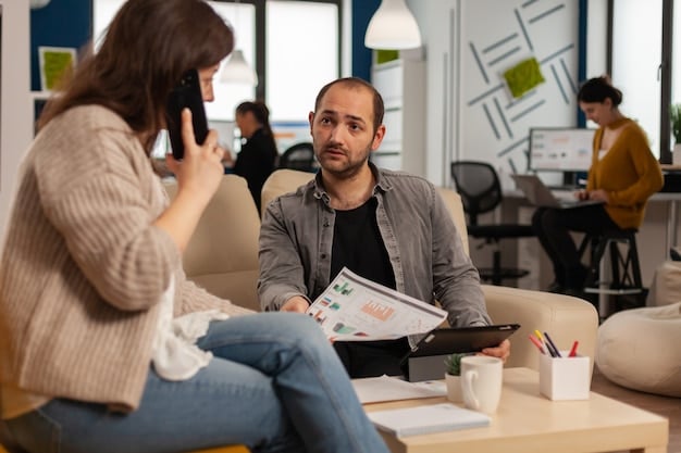 A person talking to a social worker in an office setting, surrounded by brochures and paperwork, indicating a personalized assistance consultation.