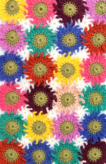 A close-up of a fabric swatch featuring a large, abstract floral print. The colors are vibrant and bold, with a mix of pink, orange, and green. The design is modern and eye-catching, perfect for making a statement.