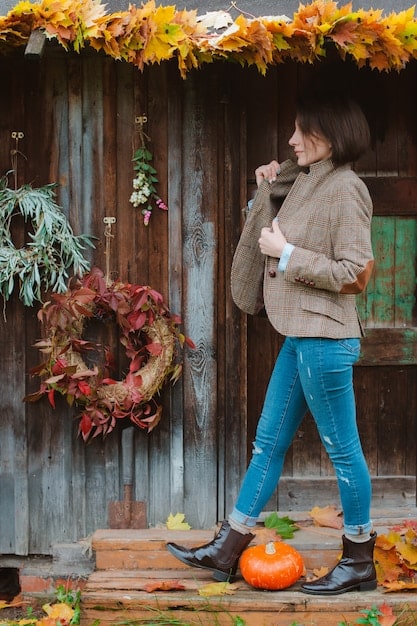 A collection of autumn-themed boots (Chelsea, combat, knee-high) against a backdrop of colorful fall leaves, representing the season's essence.