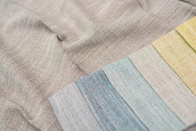 A close-up shot of pastel-colored linen and cotton fabrics swatches, with textures clearly visible. The fabrics are neatly arranged, showcasing their softness and breathability, ideal for spring clothing.
