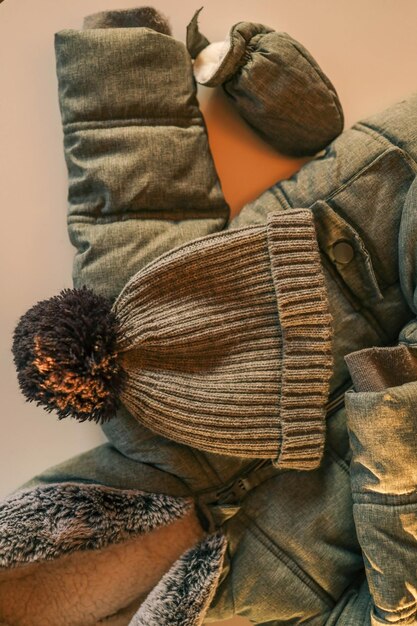 A collage showcasing different types of outerwear suitable for various climates in the US, including a lightweight rain jacket, a fleece jacket, a down vest, and a heavy parka.