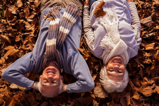 A split image showing two contrasting outfits: one is a person overdressed in heavy layers for a warm spring day, and the other is someone underdressed in light clothing for a chilly autumn evening.
