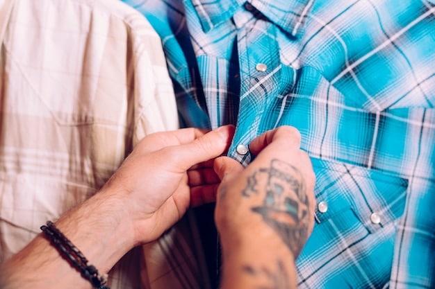 A close-up shot of a hand inspecting the stitching on a Shein men's shirt. The hand is gently pulling at the seams to demonstrate the quality and strength of the stitching. The background is blurred to keep the focus on the detail of the seam.