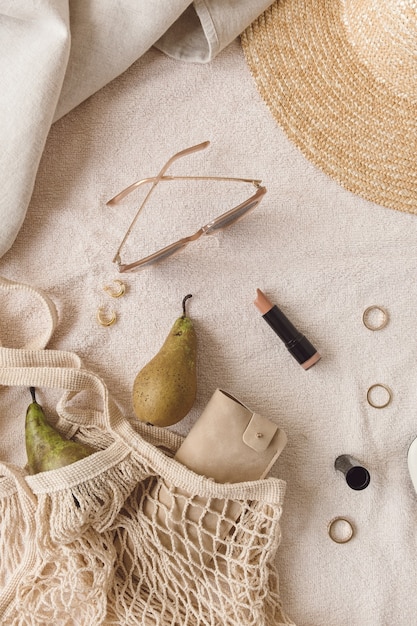 A photo showcasing a curated selection of Shein accessories in a neutral color palette (beige, white, gold). The accessories include a simple gold necklace, a beige crossbody bag, white sunglasses, and a delicate bracelet. They are arranged neatly to show how they can be mixed and matched easily.