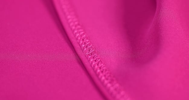 A swatch of different swimsuit fabrics, including polyester, spandex, and nylon. The close-up showcases the texture and weave of each material, highlighting their unique characteristics.