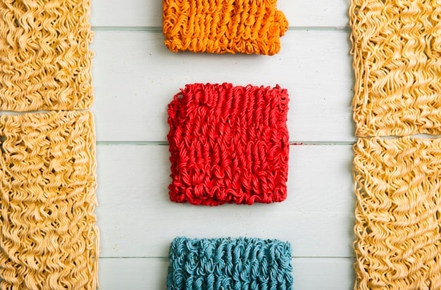 A close-up shot of various fabric swatches, including organic cotton, recycled polyester, and bamboo fibers, showcasing the textures and colors of the eco-friendly materials. Tags with sustainability certifications are visible on some of the swatches, emphasizing their eco-conscious origins.