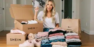 Young woman unboxing a large Shein haul with trendy clothes, smiling confidently.